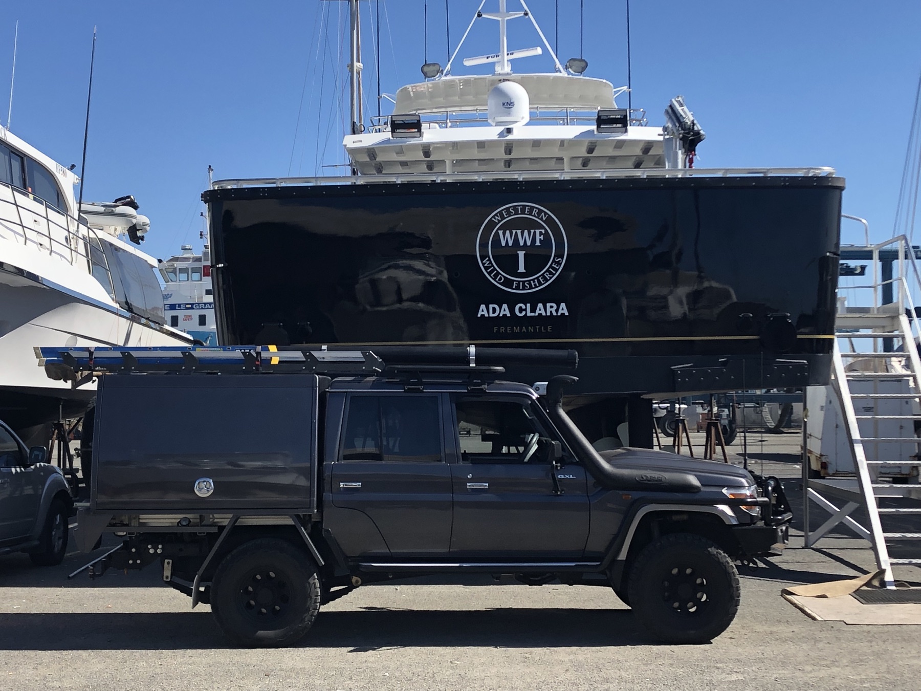 Land and Sea field vehicle beside a commercial vessel